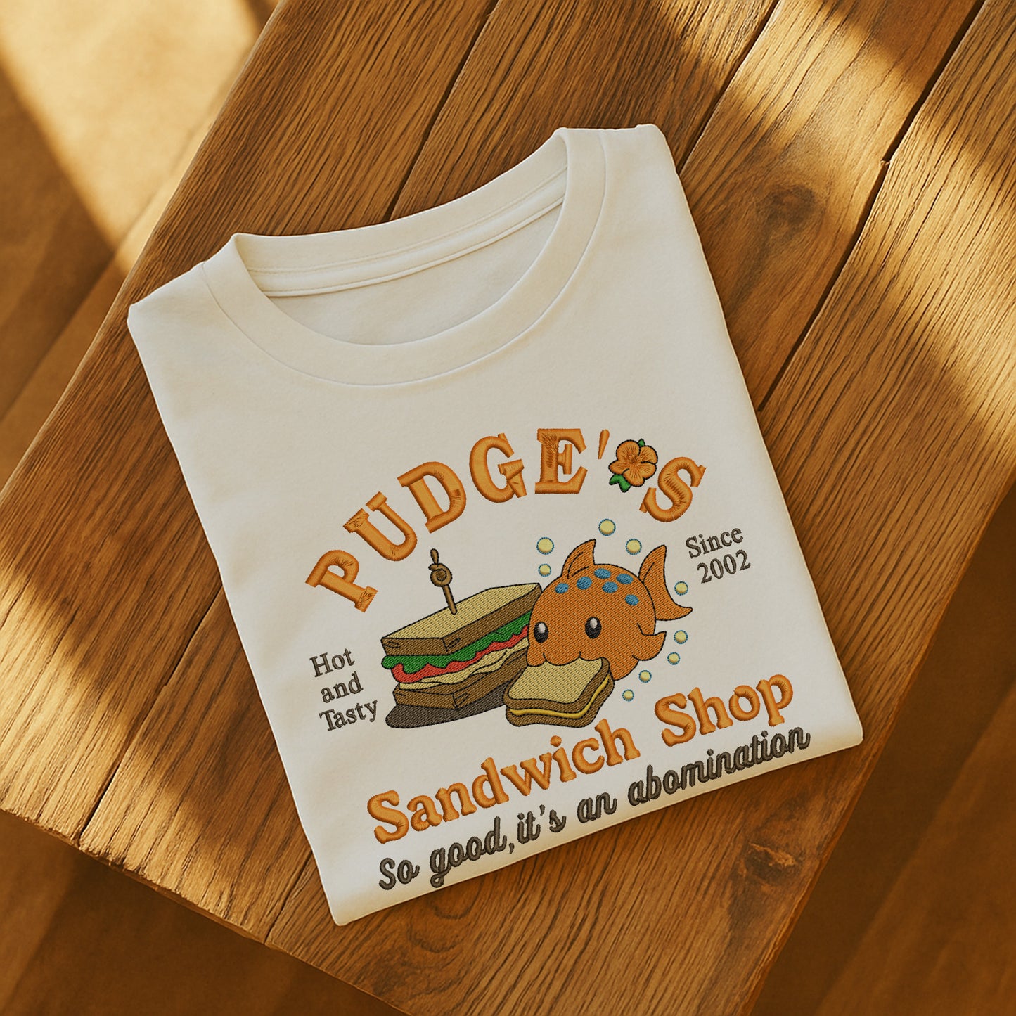 Pudge’s Sandwich Shop, Pudge Controls The Weather Fish Lilo & Stitch Embroidered Shirt